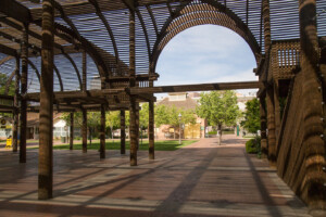 Under the shade of Heritage Square's Lath Pavilion, looking back towards the Visitor Center Carriage House.
