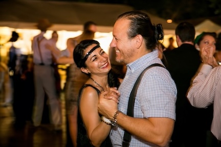 A picture of two people smiling and dancing at a Heritage Square event.